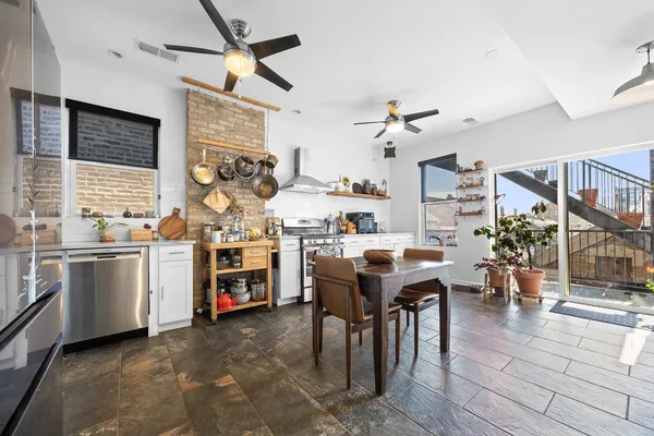 a kitchen with granite countertop cabinets a sink and appliances