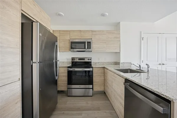 a kitchen with a sink stainless steel appliances and cabinets
