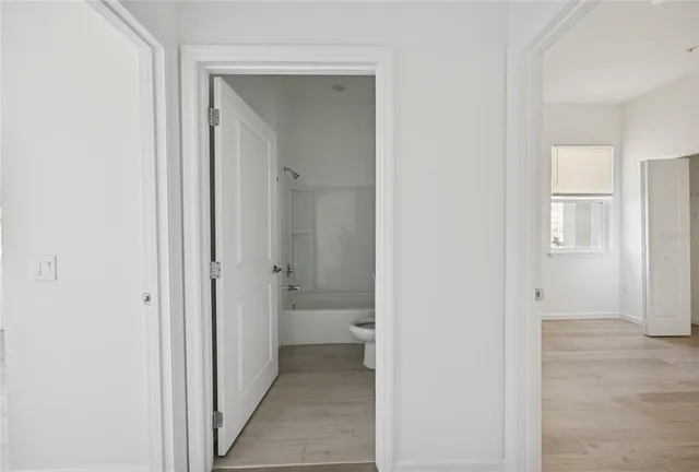 a view of a bathroom from the hallway with toilet