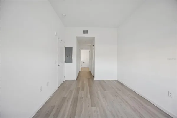 a view of a room with wooden floor and white walls