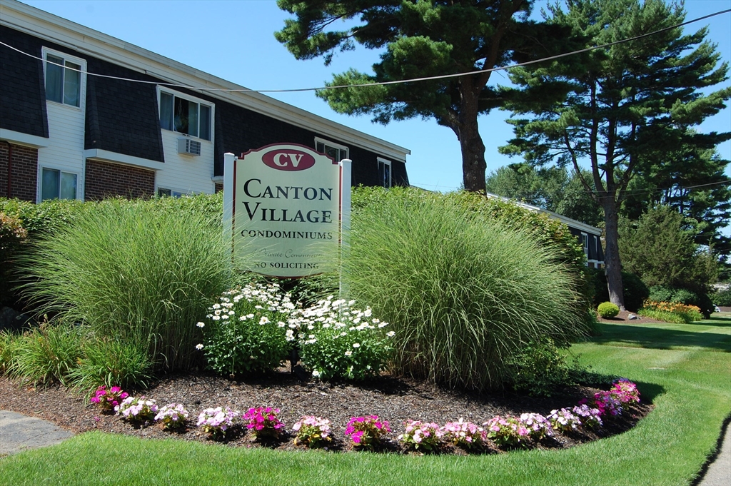 a sign that is in front of flowers