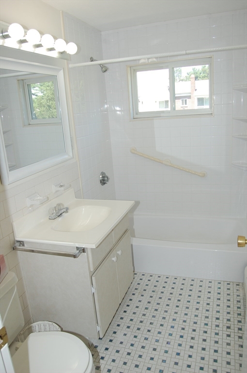 48 Will Drive, Unit 72 Canton, MA 02021 - Photo 12 of 19 a bathroom with a sink a toilet a mirror and shower