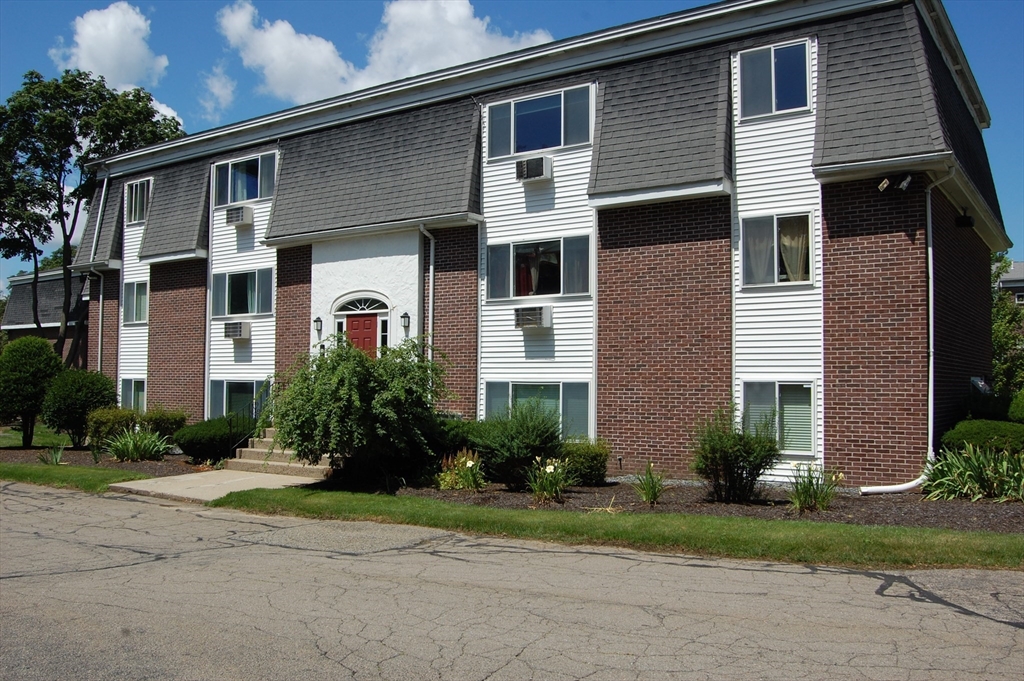 48 Will Drive, Unit 72 Canton, MA 02021 - Photo 2 of 19 a front view of a house with a yard and outdoor seating
