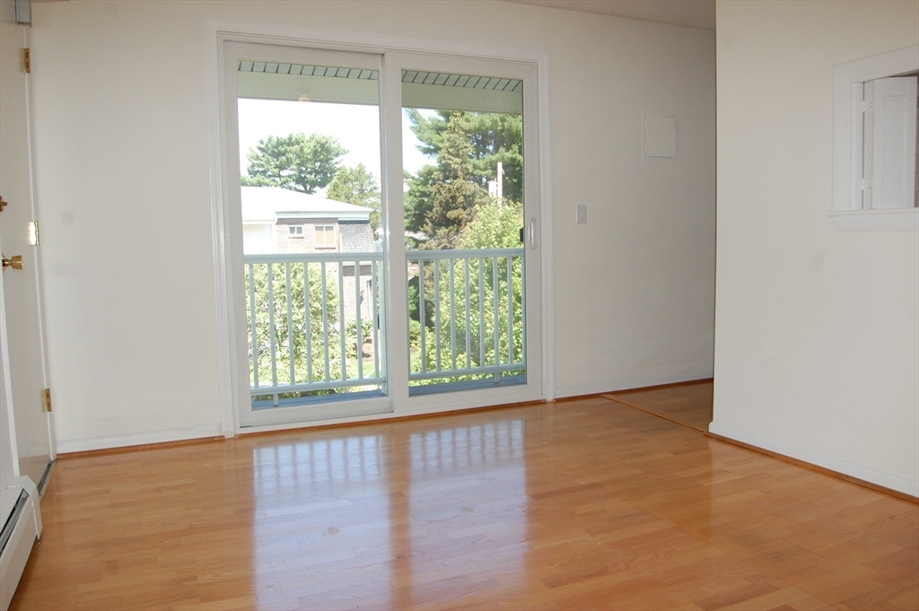 48 Will Drive, Unit 72 Canton, MA 02021 - Photo 6 of 19 a view of an empty room with wooden floor and a window