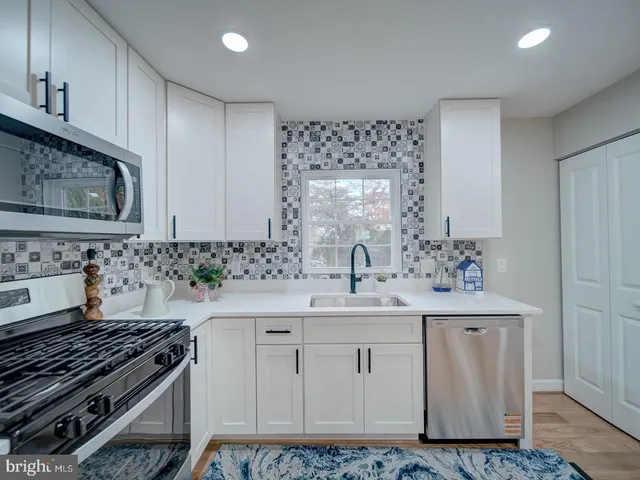 a kitchen with a sink stove and cabinets