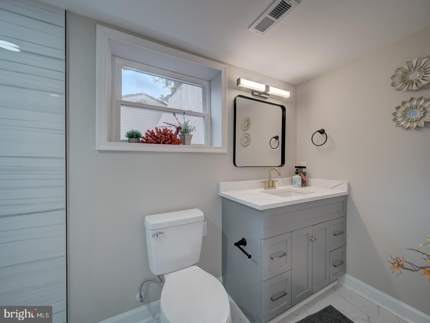 112 Courtney Drive Elkton, MD 21921 - Photo 36 of 40 a bathroom with a toilet sink and mirror