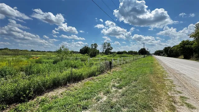 a view of a big yard with lots of green space