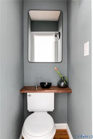 a white toilet sitting next to a bathroom sink