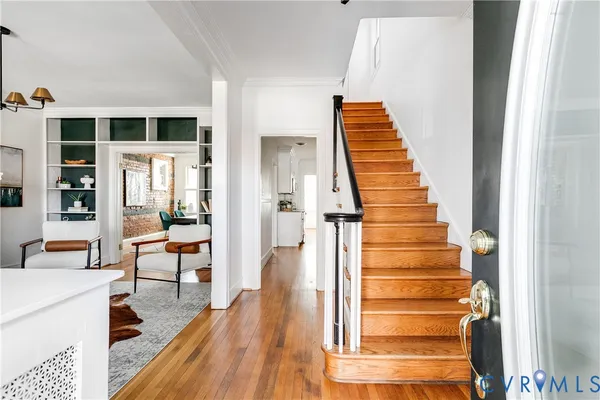 a view of entryway and hall with wooden floor
