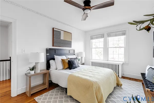 a bedroom with a large bed and a chandelier