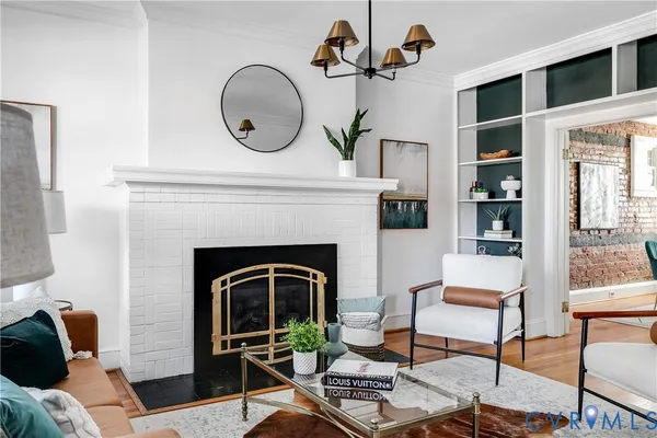 a living room with furniture and a fireplace
