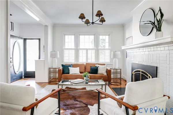 a living room with furniture fireplace and window