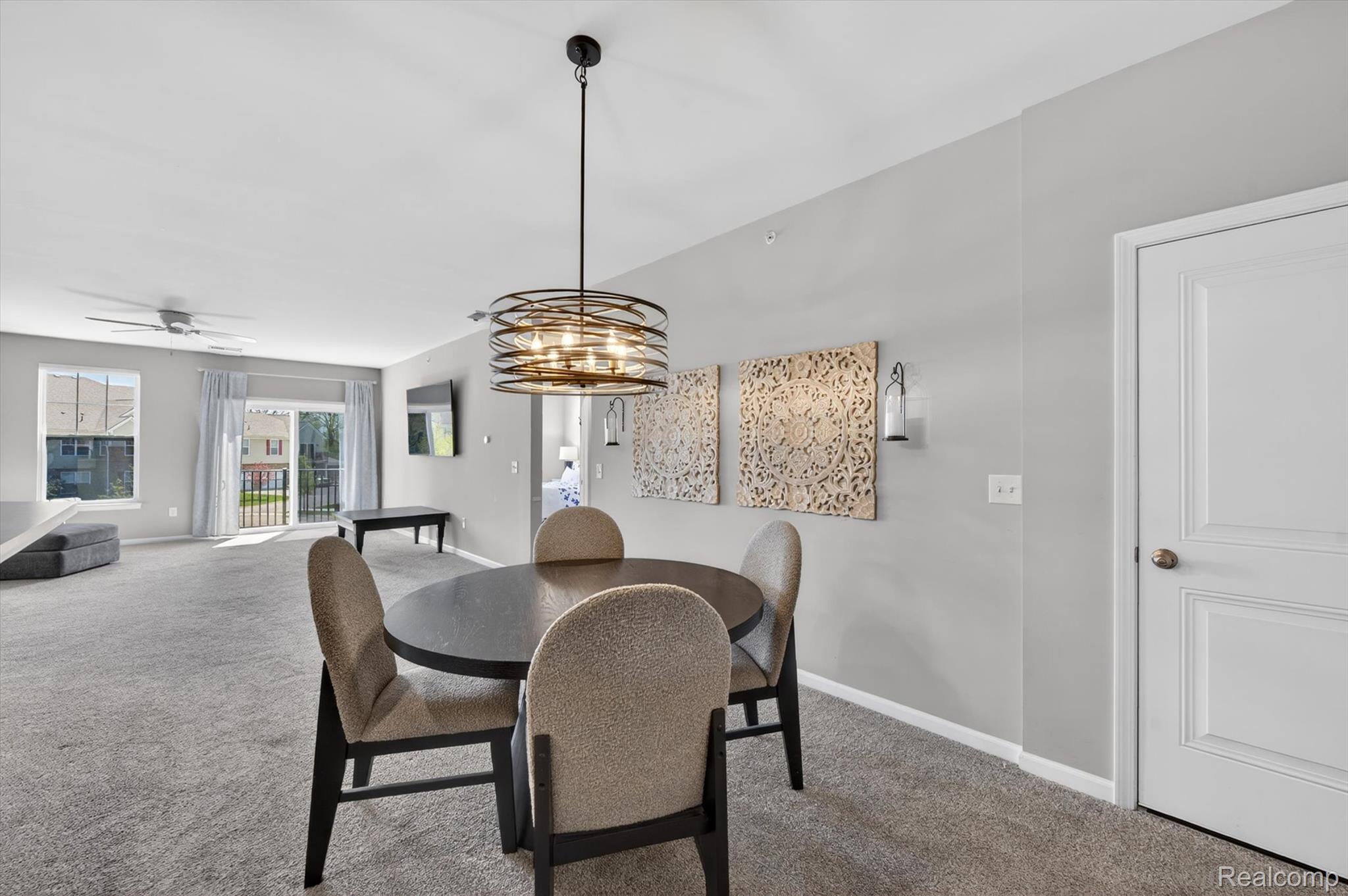 9789 Ridge Run Street Howell, MI 48855 - Photo 7 of 23 Dining area with modern lighting and open layout connecting the kitchen and living spaces.