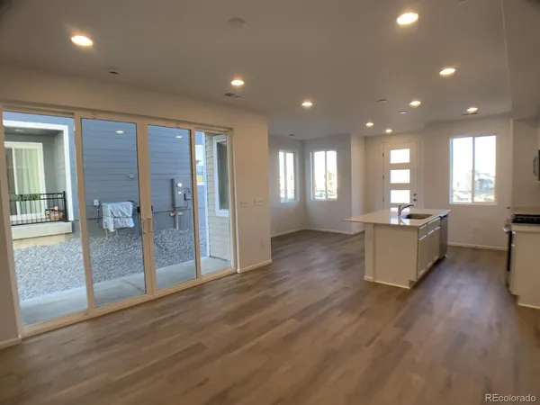 a view of a kitchen with a sink and a refrigerator