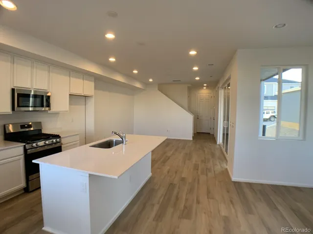 a kitchen with a sink and a stove top oven