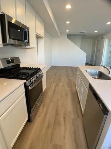 a kitchen that has a sink and a stove in it