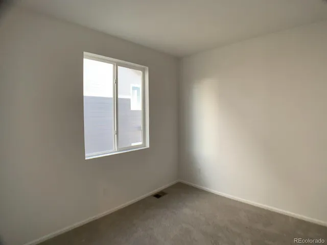a view of an empty room and a utility room