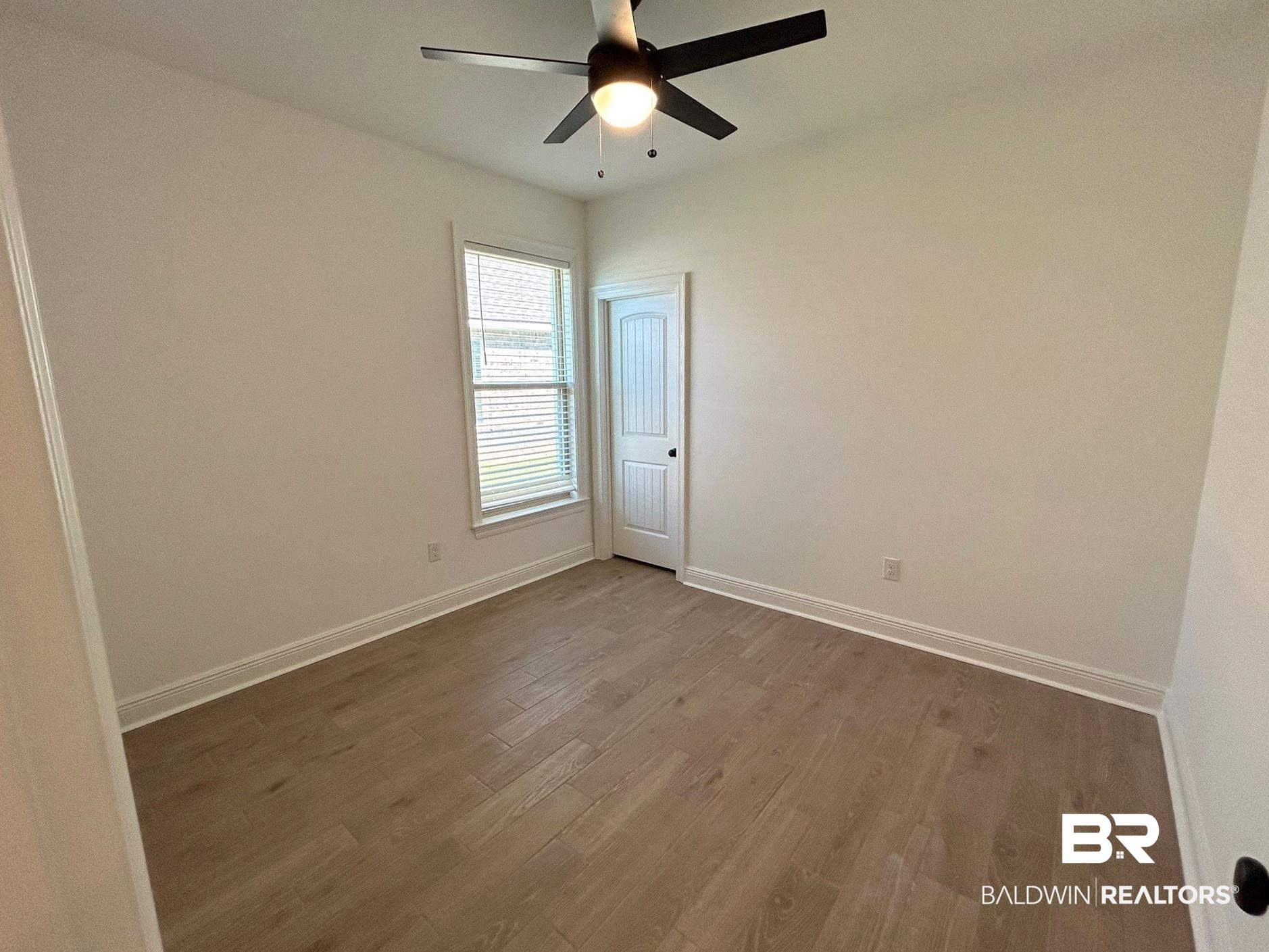 812 Sumter Loop Foley, AL 36535 - Photo 10 of 17 Empty room featuring ceiling fan and wood-type flooring