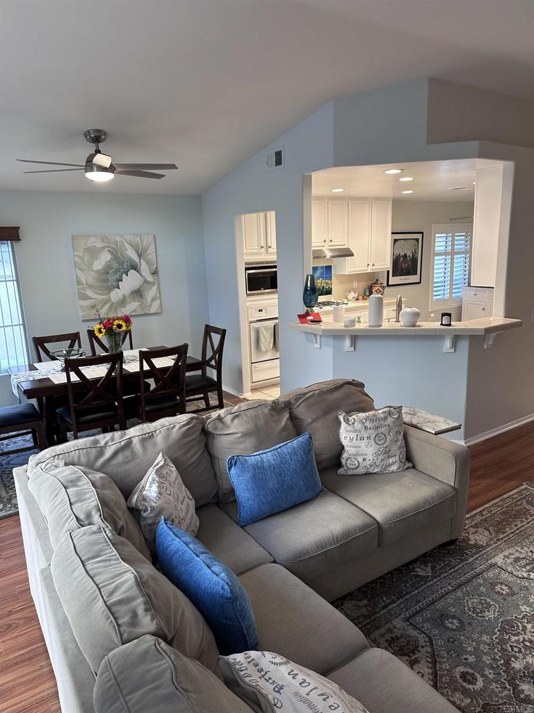 a living room with furniture and a wooden floor