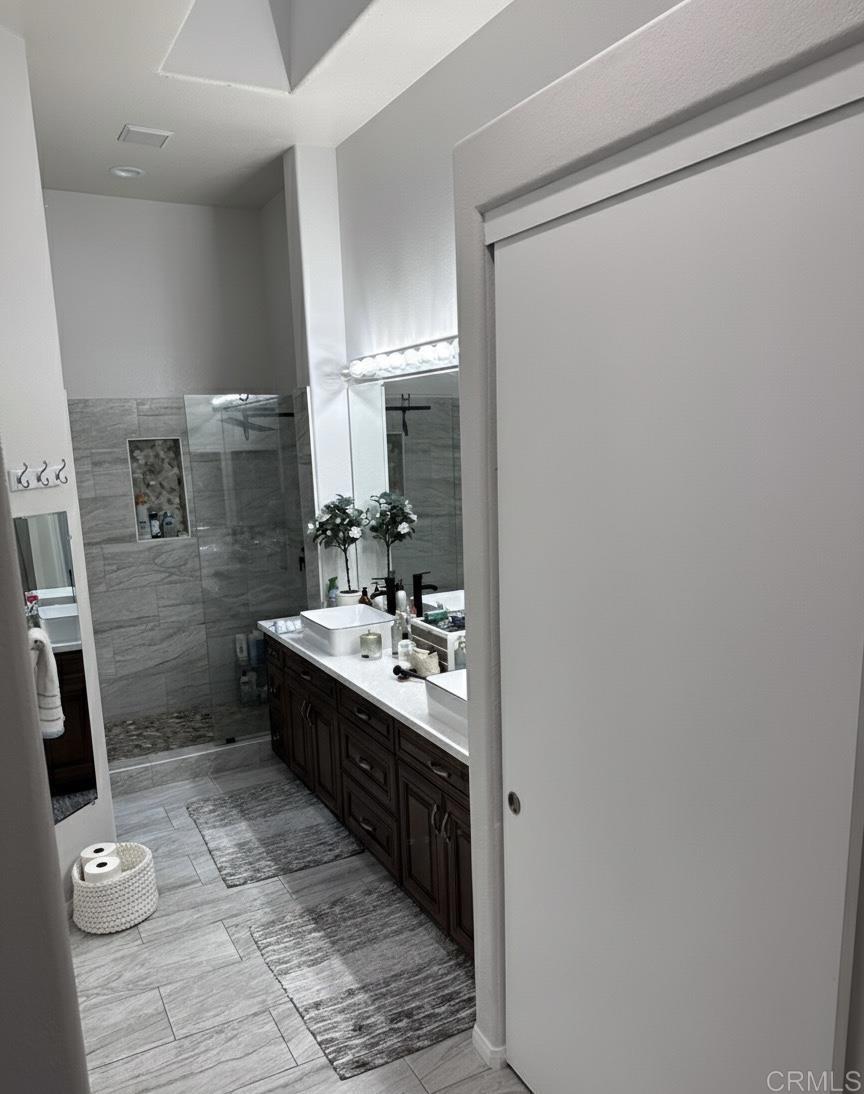 2547 La Costa Avenue Chula Vista, CA 91915 - Photo 14 of 17 a bathroom with a sink a toilet a mirror and vanity