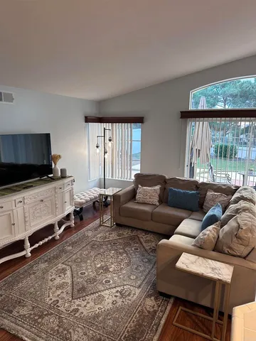 a living room with furniture and a flat screen tv