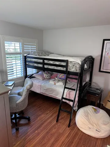 a bedroom with a bed and a chair
