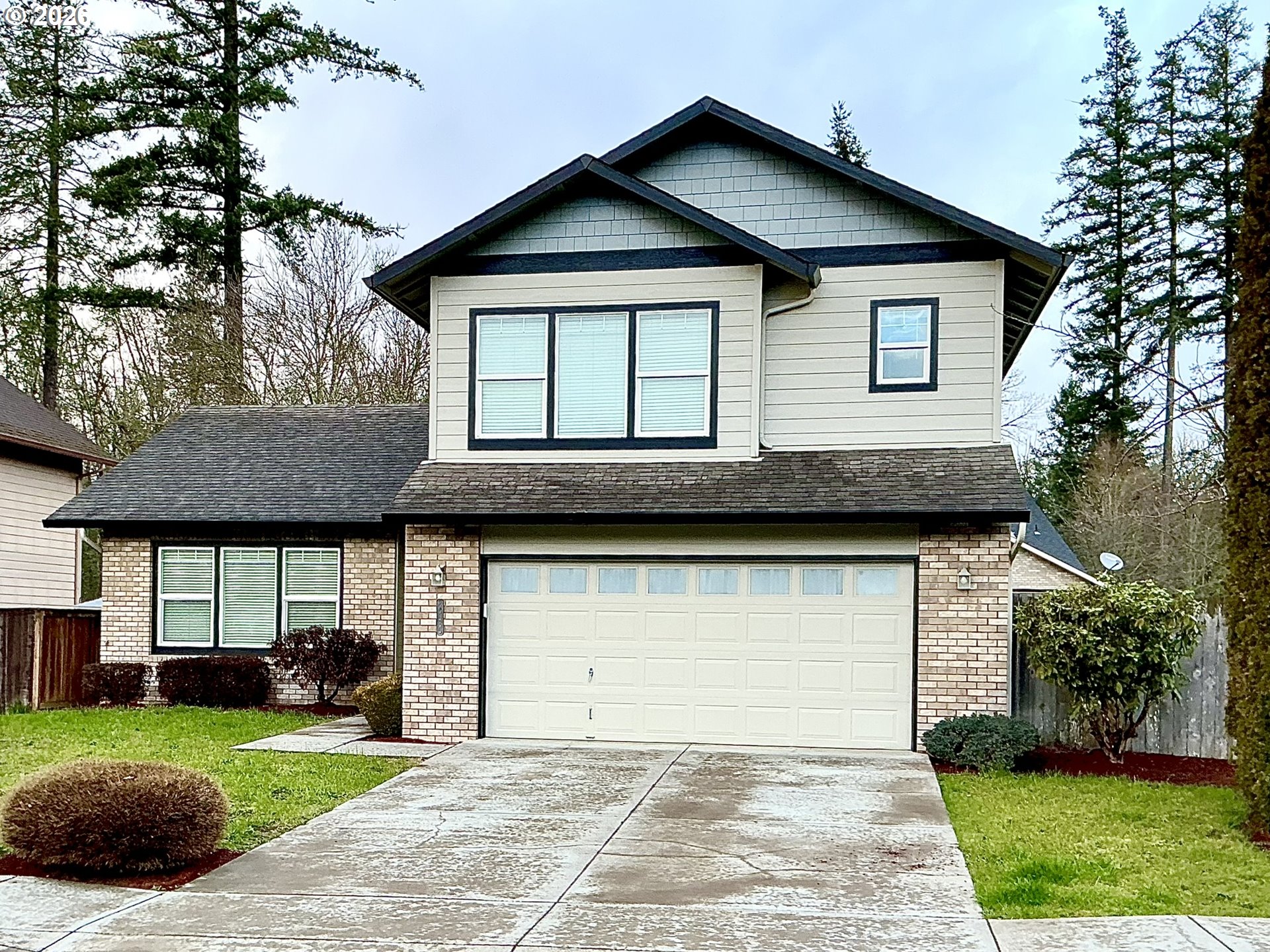 a front view of a house with a garden and plants