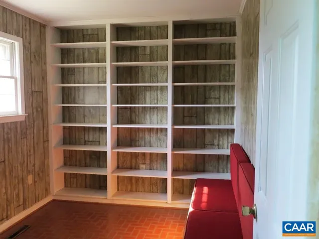 a view of an empty room with empty shelves