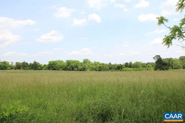 a view of a lake with houses in the back