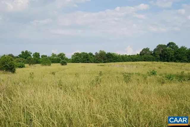 a view of a lake with houses in the back