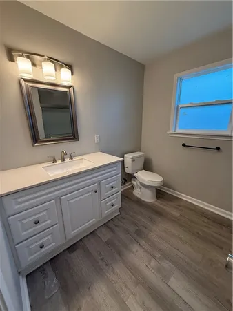 a spacious bathroom with a double vanity sink and a mirror