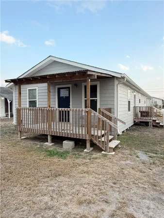 a view of a house with wooden fence