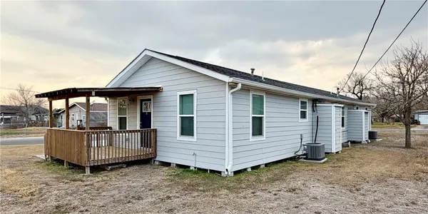 a view of a house with a yard and roof