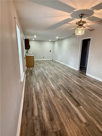 a view of a livingroom with a hall and furniture