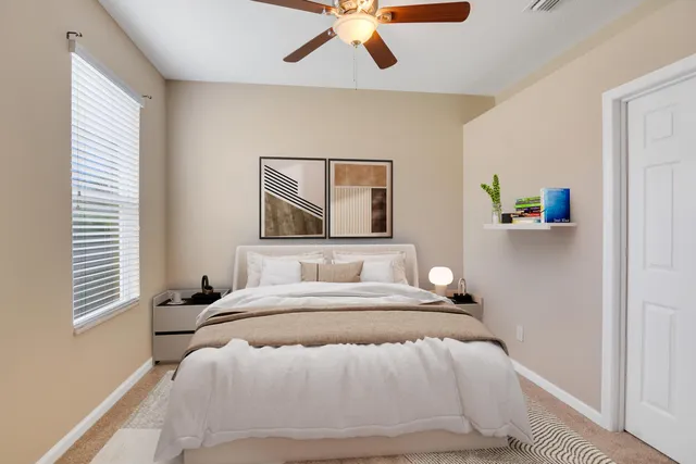 a bedroom with a bed and a painting on the wall