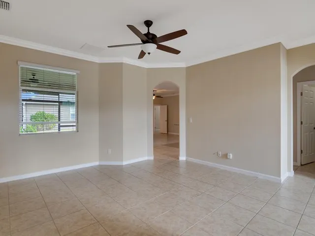 a view of a livingroom with a ceiling fan & a ceiling fan