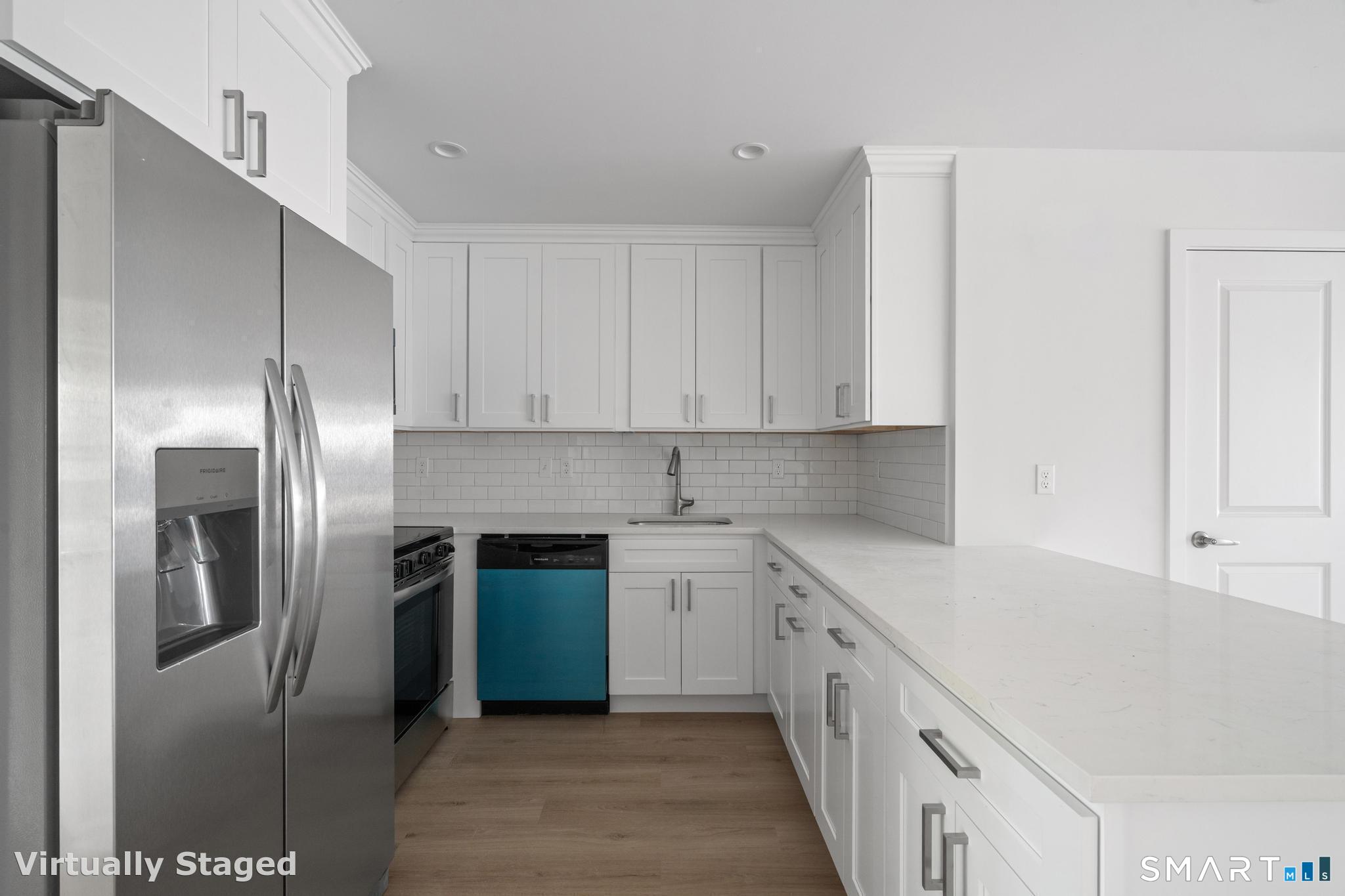 27 Village Road, Unit C Milford, CT 06460 - Photo 10 of 14 a kitchen with stainless steel appliances granite countertop a refrigerator and a sink