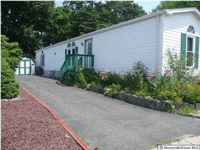 46 Ruffian Way Howell, NJ 07731 - Photo 2 of 3 a backyard of a house with plants and trees