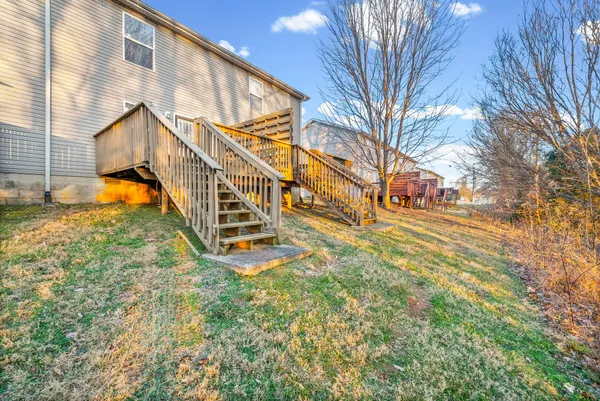 a view of an house with backyard and sitting area