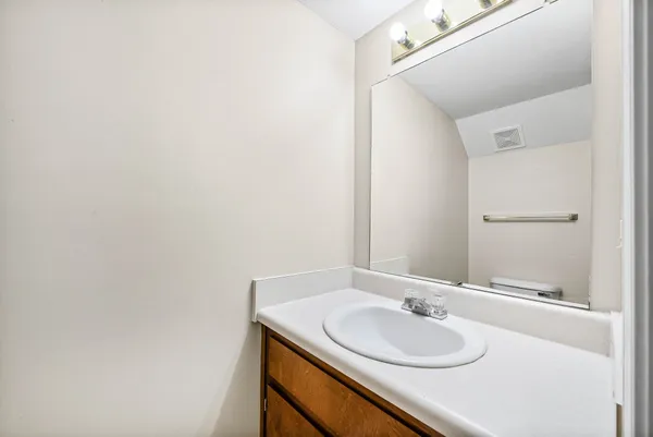 a bathroom with a granite countertop sink and a mirror