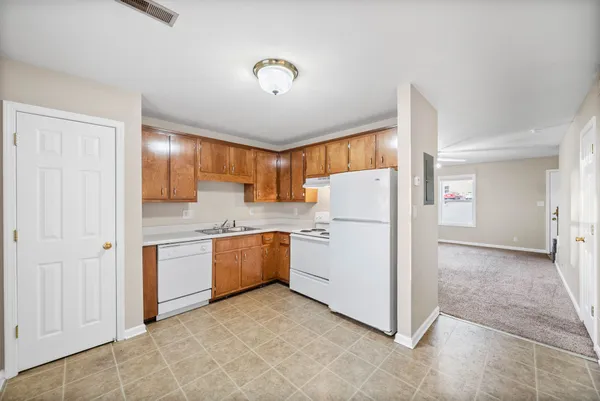 a kitchen with refrigerator and cabinets