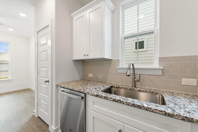 a kitchen with appliances a sink and a refrigerator