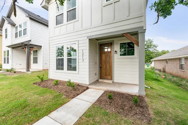 a front view of a house with a garden