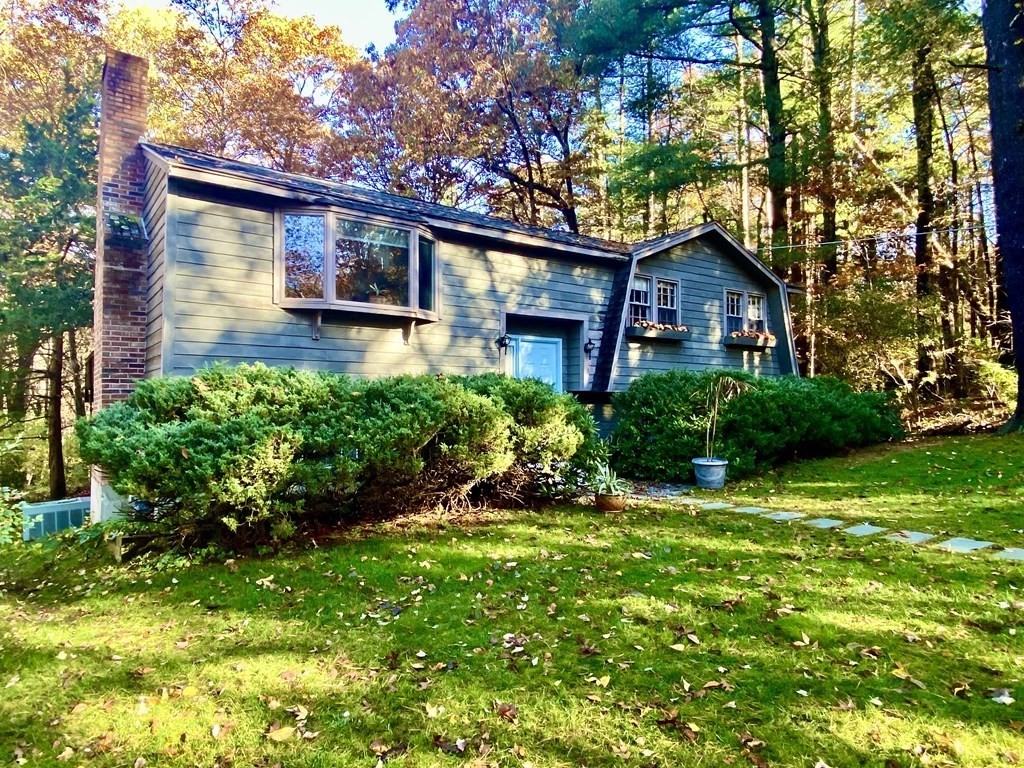 11 Groton Road Tyngsboro, MA 01879 - Photo 2 of 12 a front view of a house with a yard and potted plants