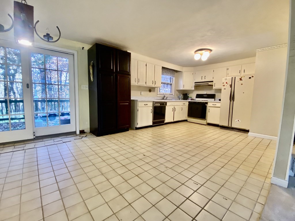11 Groton Road Tyngsboro, MA 01879 - Photo 4 of 12 a kitchen with stainless steel appliances a refrigerator and a stove top oven