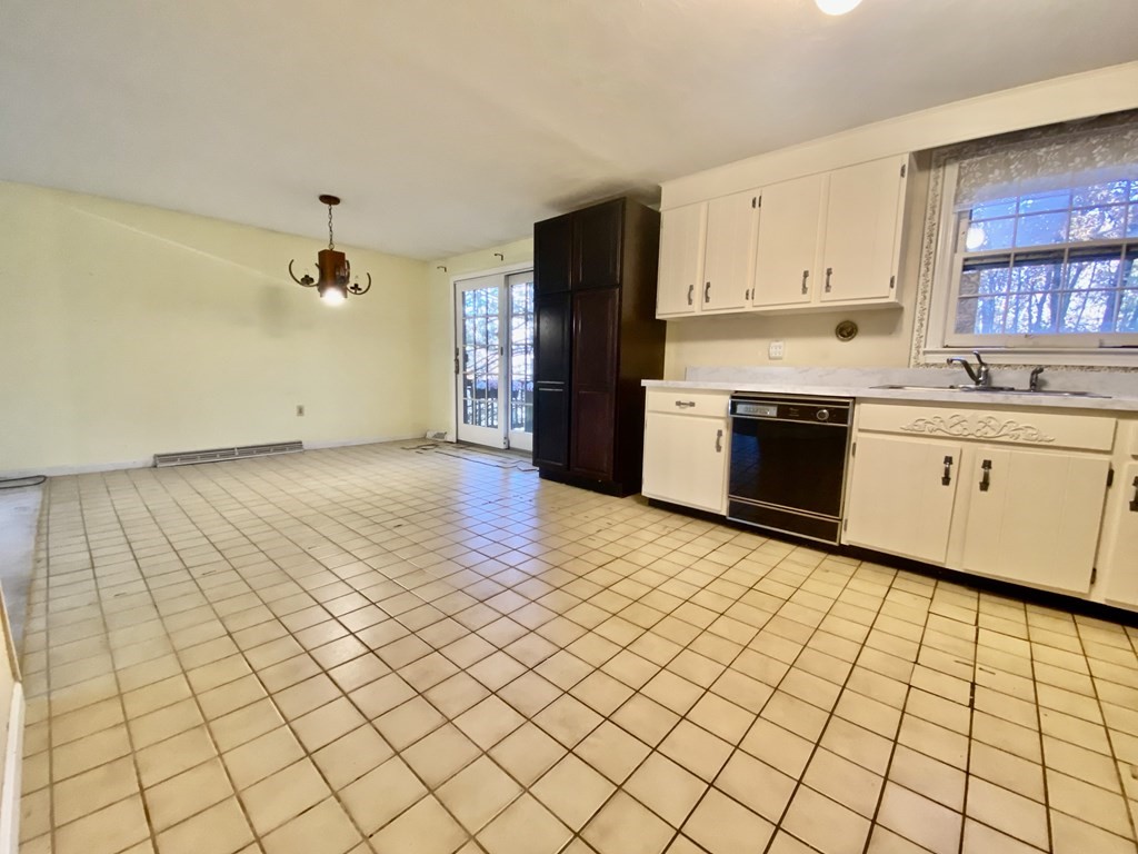11 Groton Road Tyngsboro, MA 01879 - Photo 6 of 12 a large kitchen with cabinets and stainless steel appliances