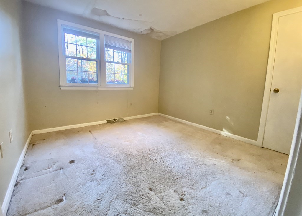 11 Groton Road Tyngsboro, MA 01879 - Photo 8 of 12 an empty room with a window