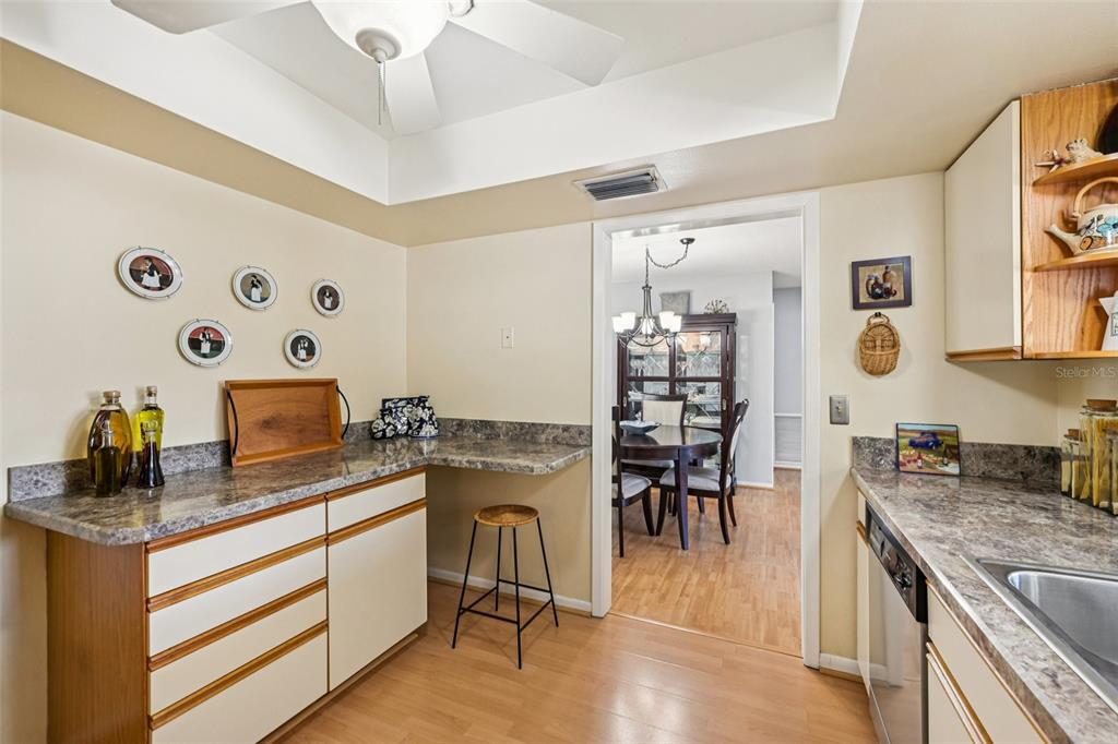 1908 49th Street West Bradenton, FL 34209 - Photo 16 of 57 a kitchen with granite countertop cabinets a dining table and chairs in it