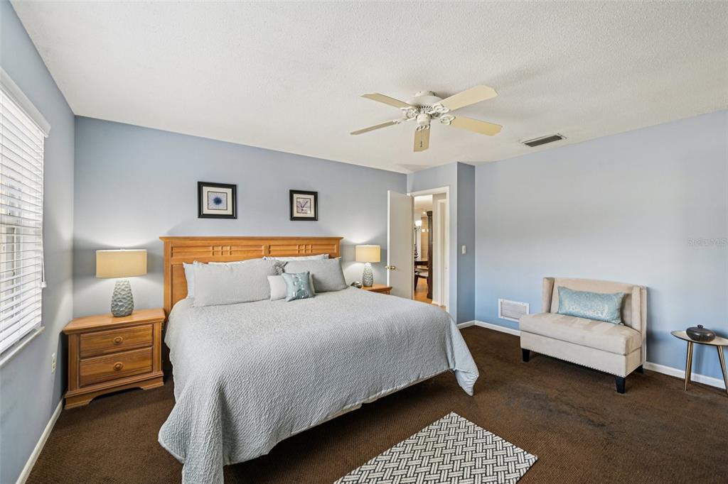 1908 49th Street West Bradenton, FL 34209 - Photo 19 of 57 a bedroom with a bed and a couch