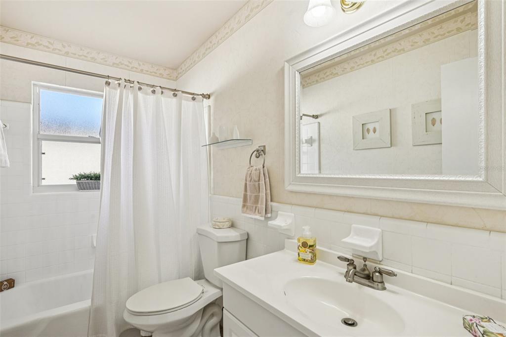 1908 49th Street West Bradenton, FL 34209 - Photo 29 of 57 a bathroom with a sink a toilet and shower